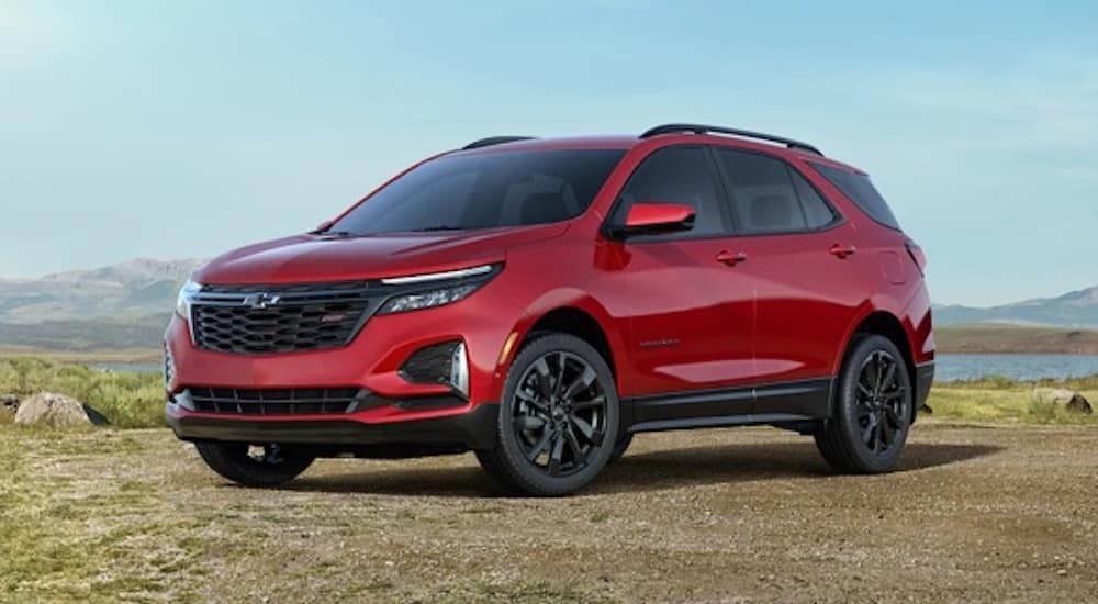 A red 2024 Chevy Equinox RS is shown from the front at an angle.