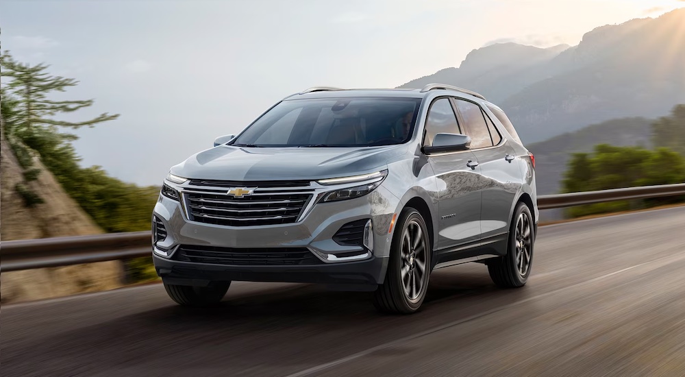 A silver 2024 Chevy Equinox driving.