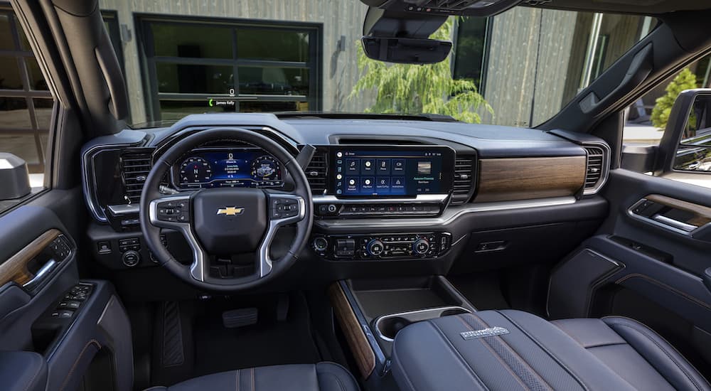 The black interior of a 2024 Chevy Silverado 1500 High Country is shown from the driver's seat.