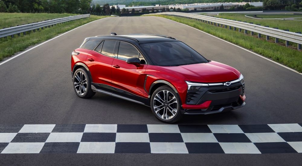 A red 2024 Chevy Blazer EV SS parked in front of a finish line.