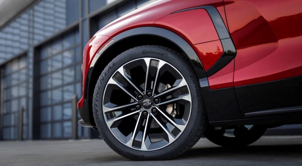 A close-up on the front wheel of a red 2024 Chevy Blazer EV SS.