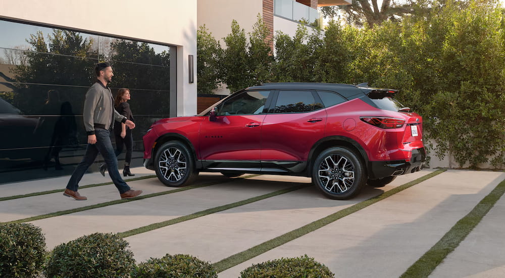 Rear view of a red 2025 Chevy Blazer parked on a driveway.