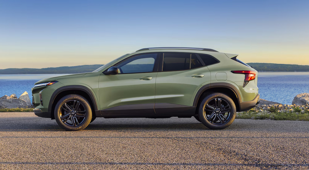 Side angle view of a green 2025 Chevy Trax parked after visiting a Chevy dealer near Whitmore Lake.