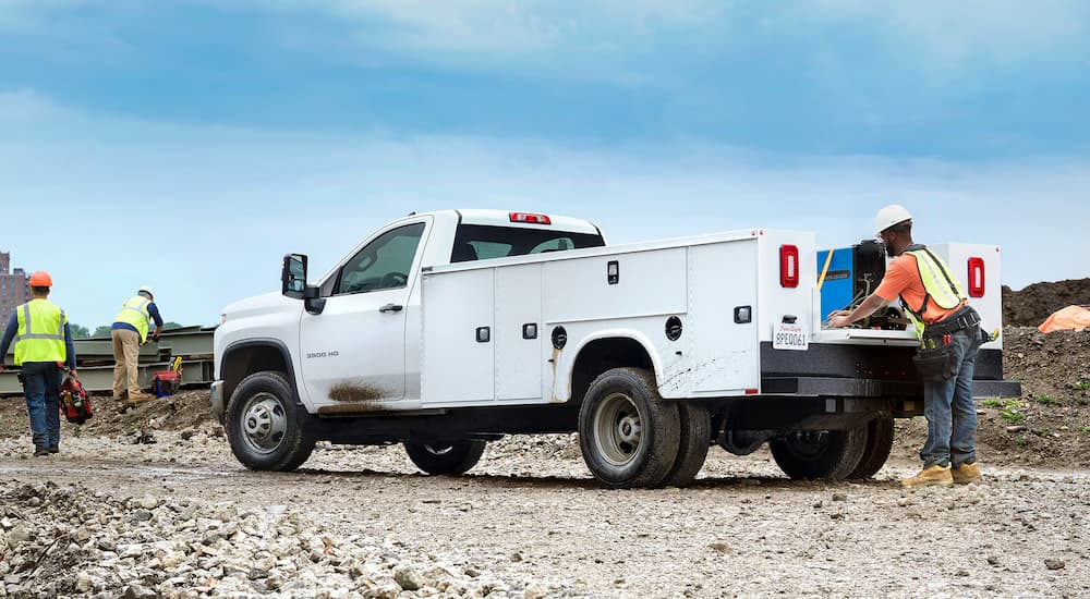 A white 2026 Chevy Silverado 3500 HD Chassis Cab parked at a construction site