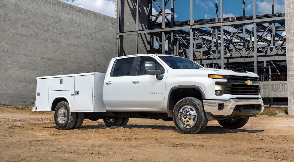 A white 2026 Chevy Silverado 3500 HD Chassis Cab parked at a jobsite