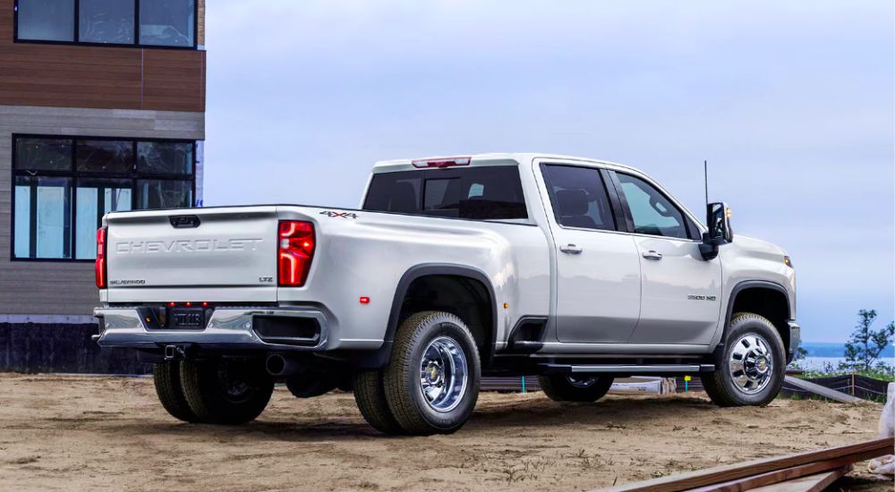 Rear view of a white 2026 Chevy Silverado 3500 HD on a construction site.
