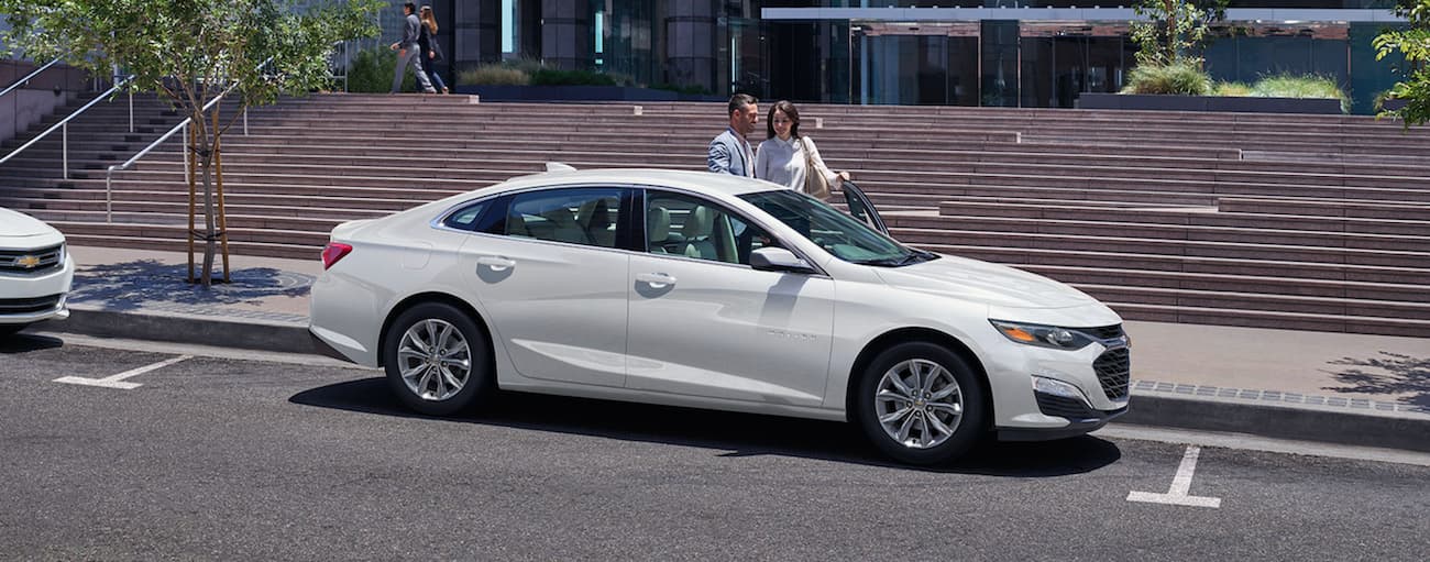 White 2020 Chevy Malibu parked on a street.