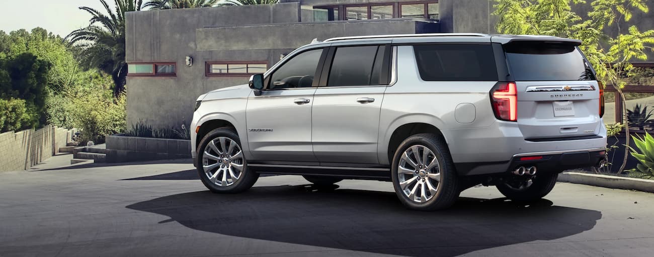 Rear of a white 2021 Chevy Suburban parked on a driveway.
