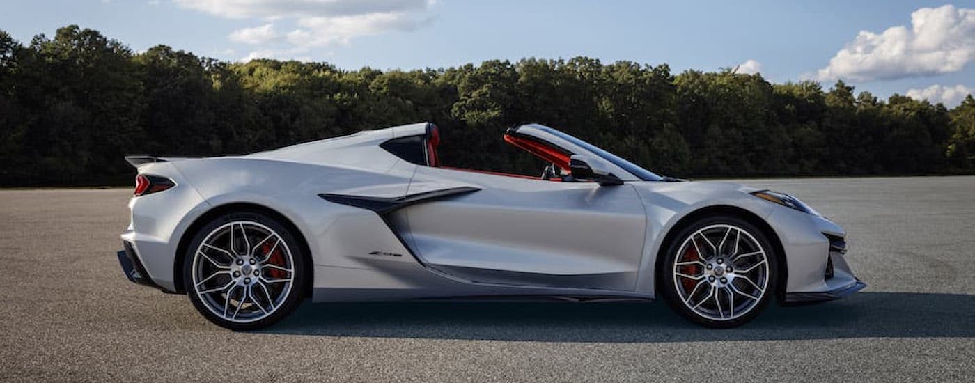 A silver 2024 Chevy Corvette Z06 is shown from the side while parked.