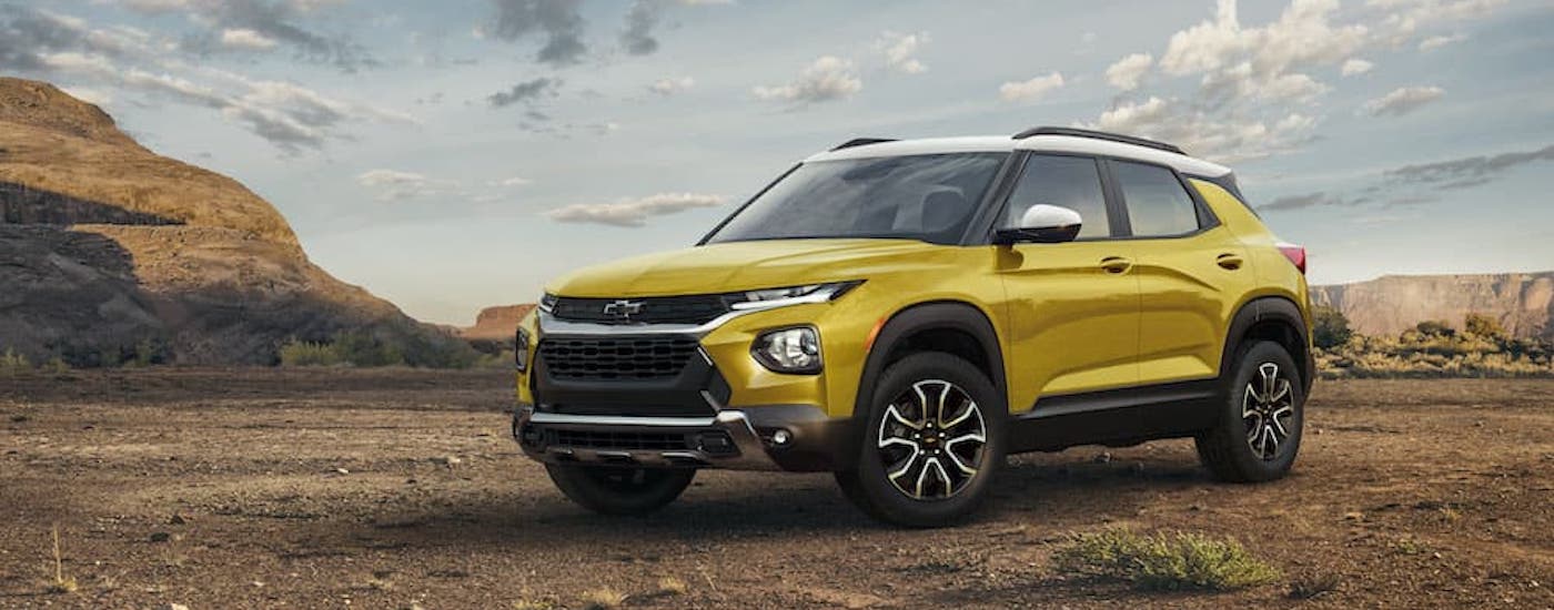 A yellow 2024 Chevy Trailblazer Activ is shown from the front at angle while off-road after leaving a Chevy dealer.