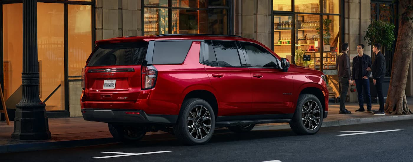 Red 2023 Chevy Tahoe parked on the side of a city street