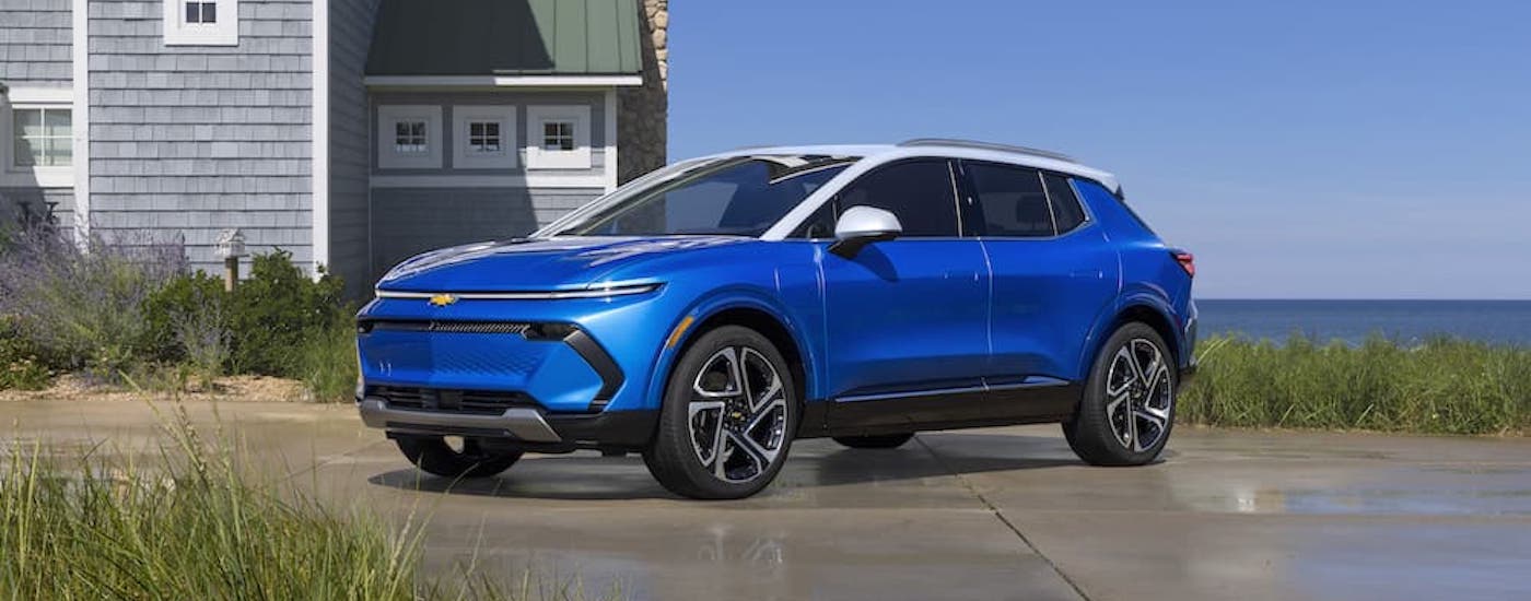 A blue 2024 Chevy Equinox EV is shown from the front at an angle.