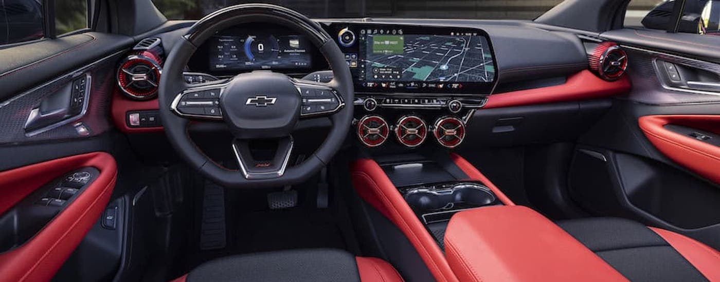 The red interior of a 2024 Chevy Blazer EV RS is shown from the driver's seat.