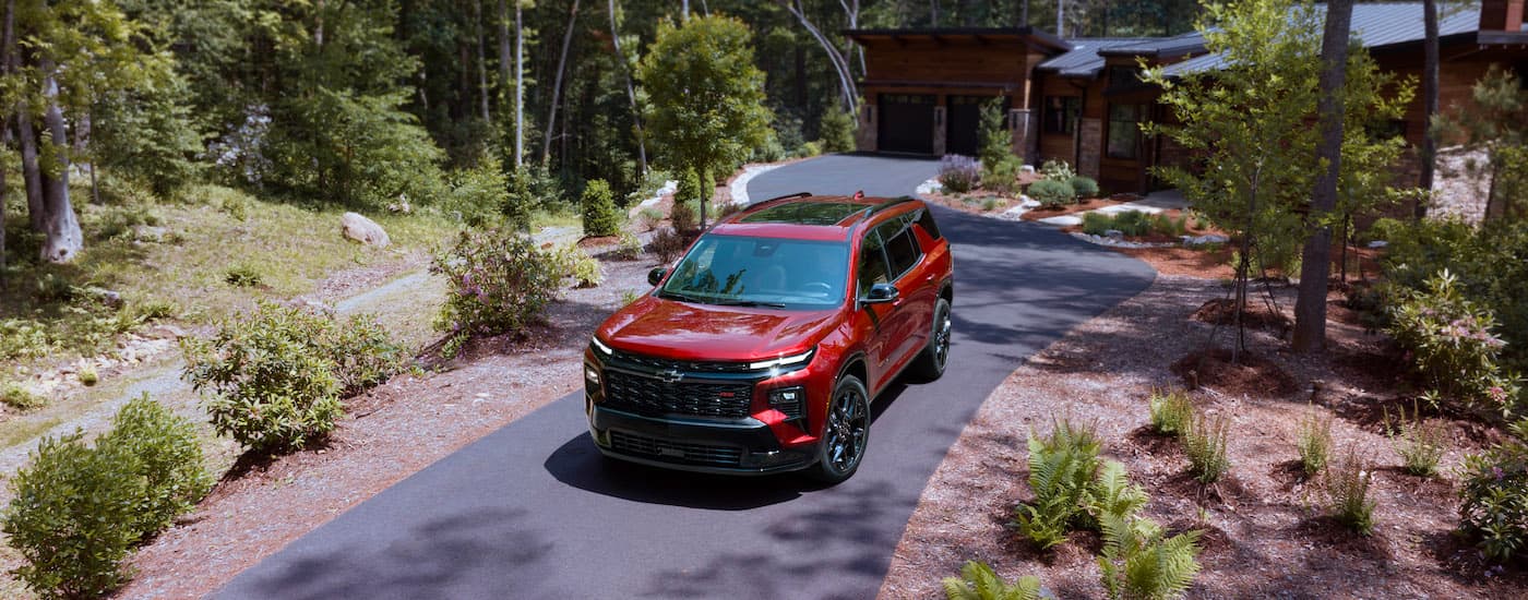 A red 2024 Chevy Traverse RS is shown from the front at an angle.
