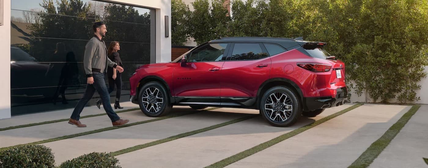 A red 2025 Chevy Blazer RS parked on a driveway.