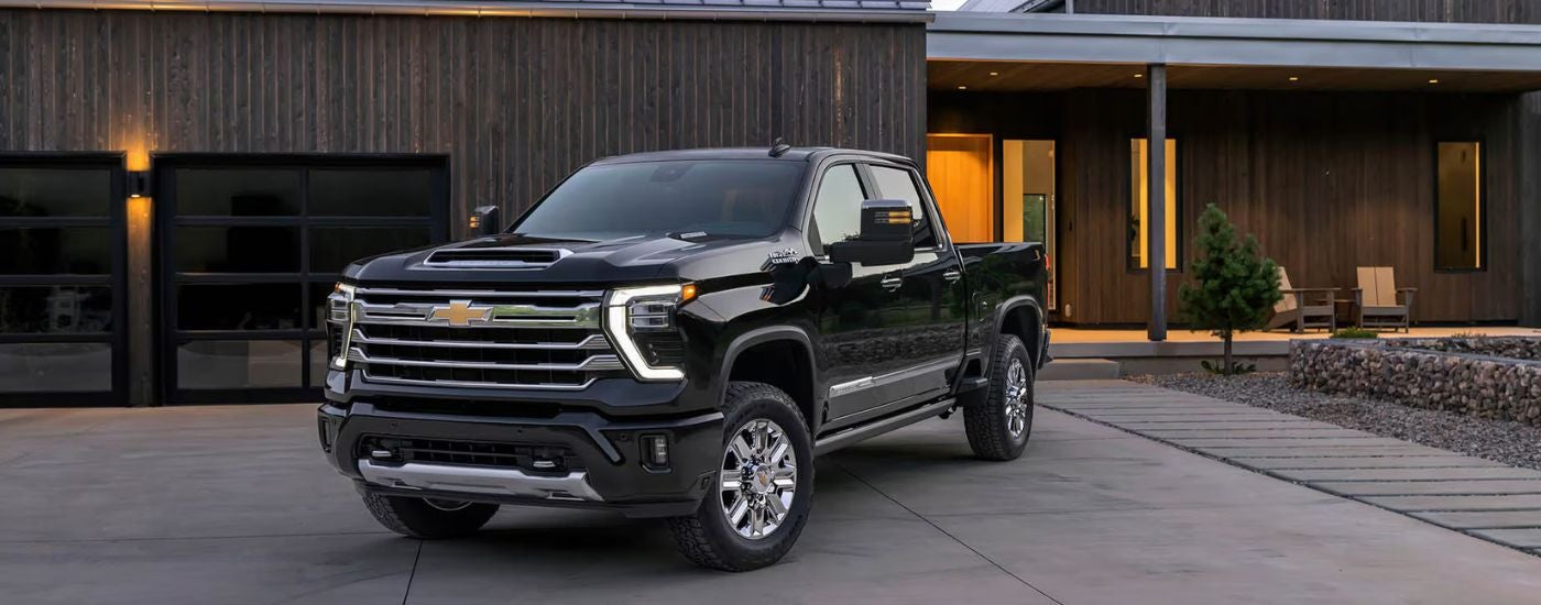 Black 2026 Chevy Silverado 2500 HD parked in a driveway.