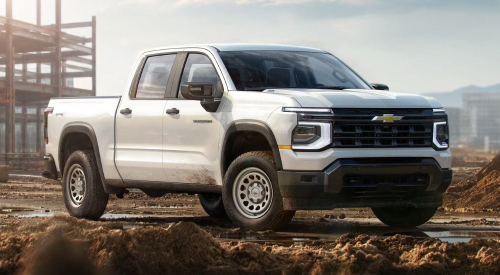 White 2027 Chevy Silverado 1500 parked on a construction site.