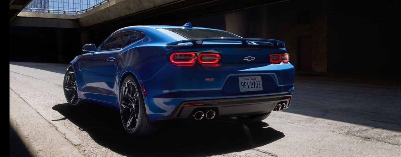 Rear of a blue 2025 Chevy Camaro SS driving through a tunnel.