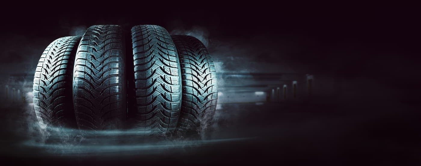 Several tires lined up in a dark environment.