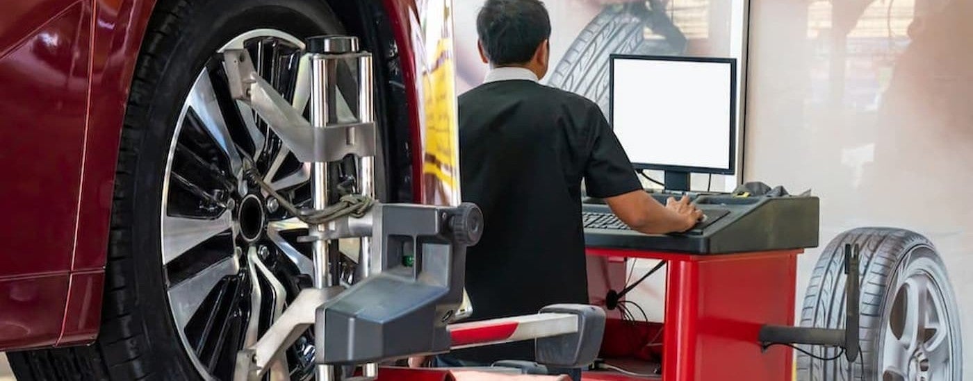 A technician performing a tire alignment.