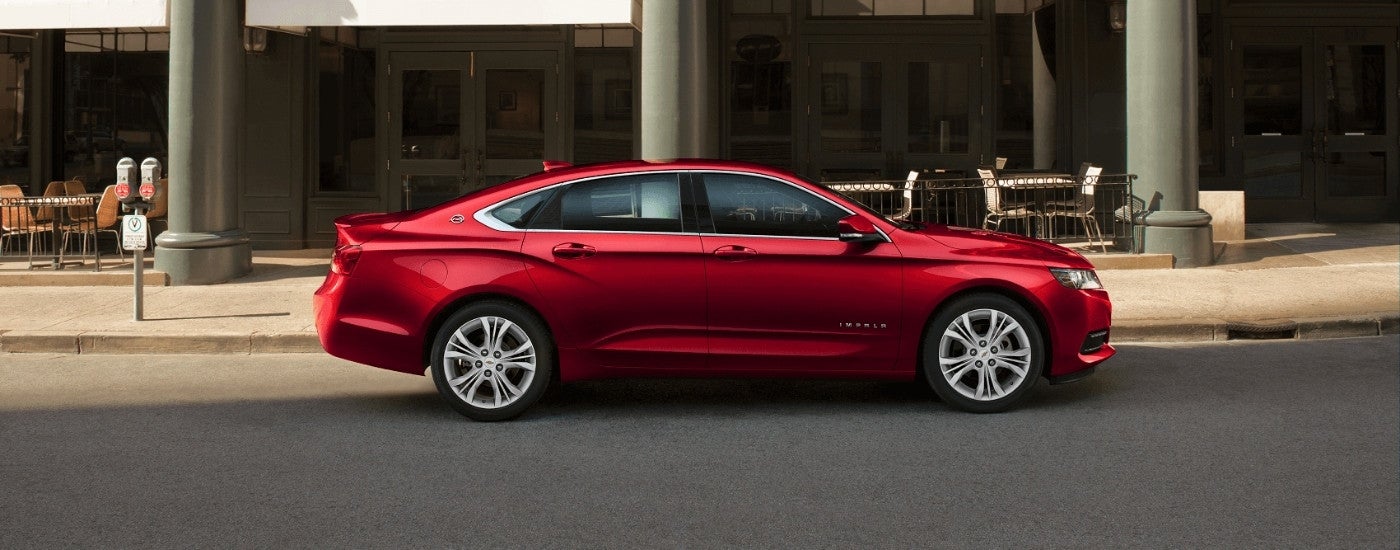 A red 2017 Chevy Impala parked on a city street.